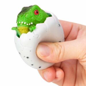 Squeezy Egg Popper toy in hand, squeezed and green dino popping out